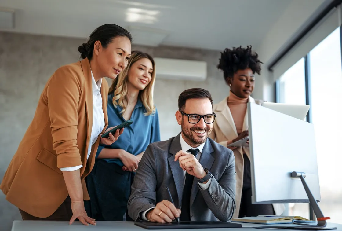 People working together at computers in an office.
